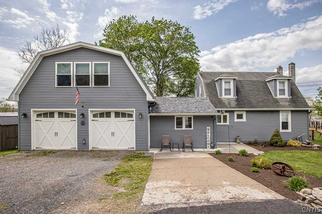 Central New York home with garage, rooflines and driveway before winter
