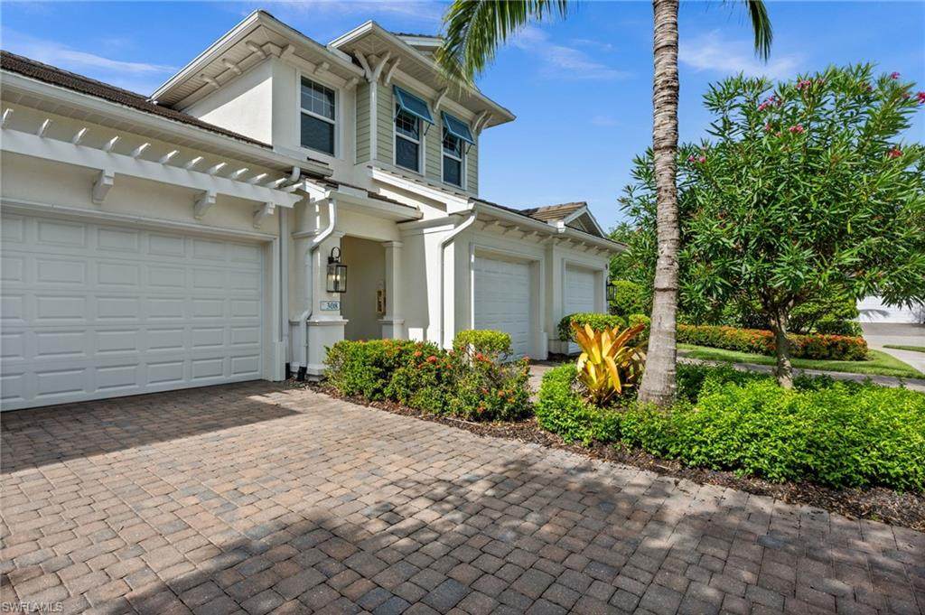 Naples condominium exterior with garages and palm landscaping